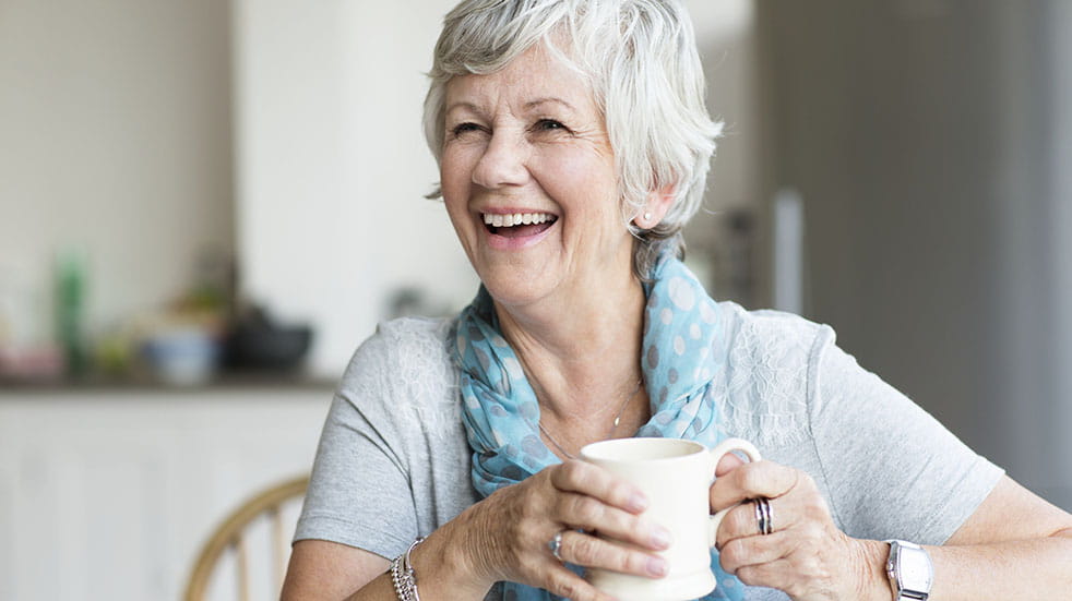 How to train yourself to sleep better; woman smiling